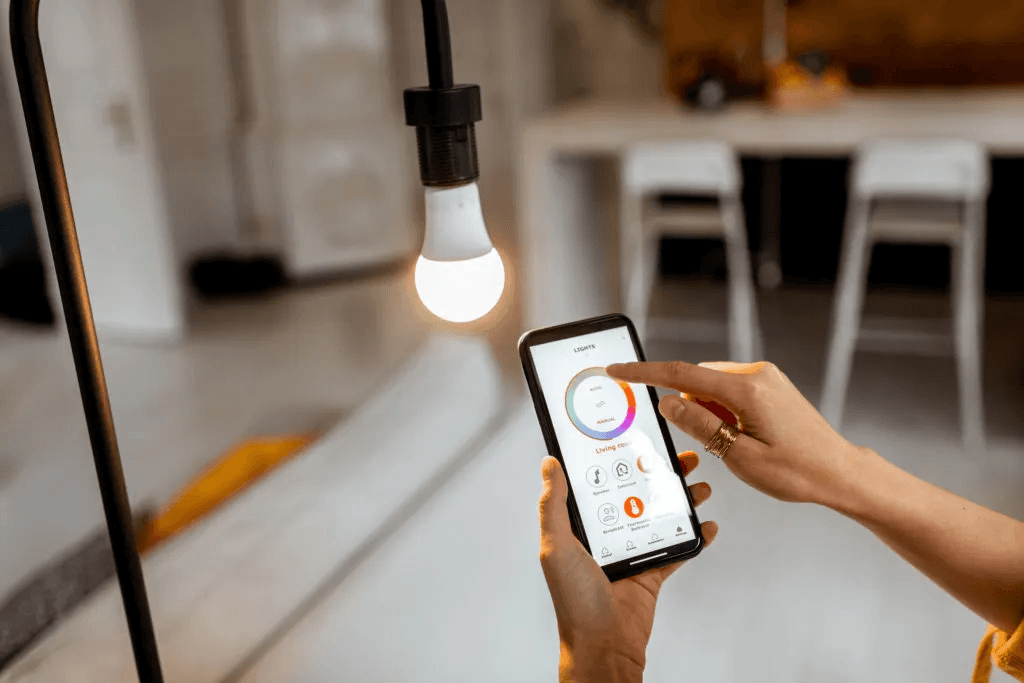 Hand controlling smart bulb color temperature via smartphone app